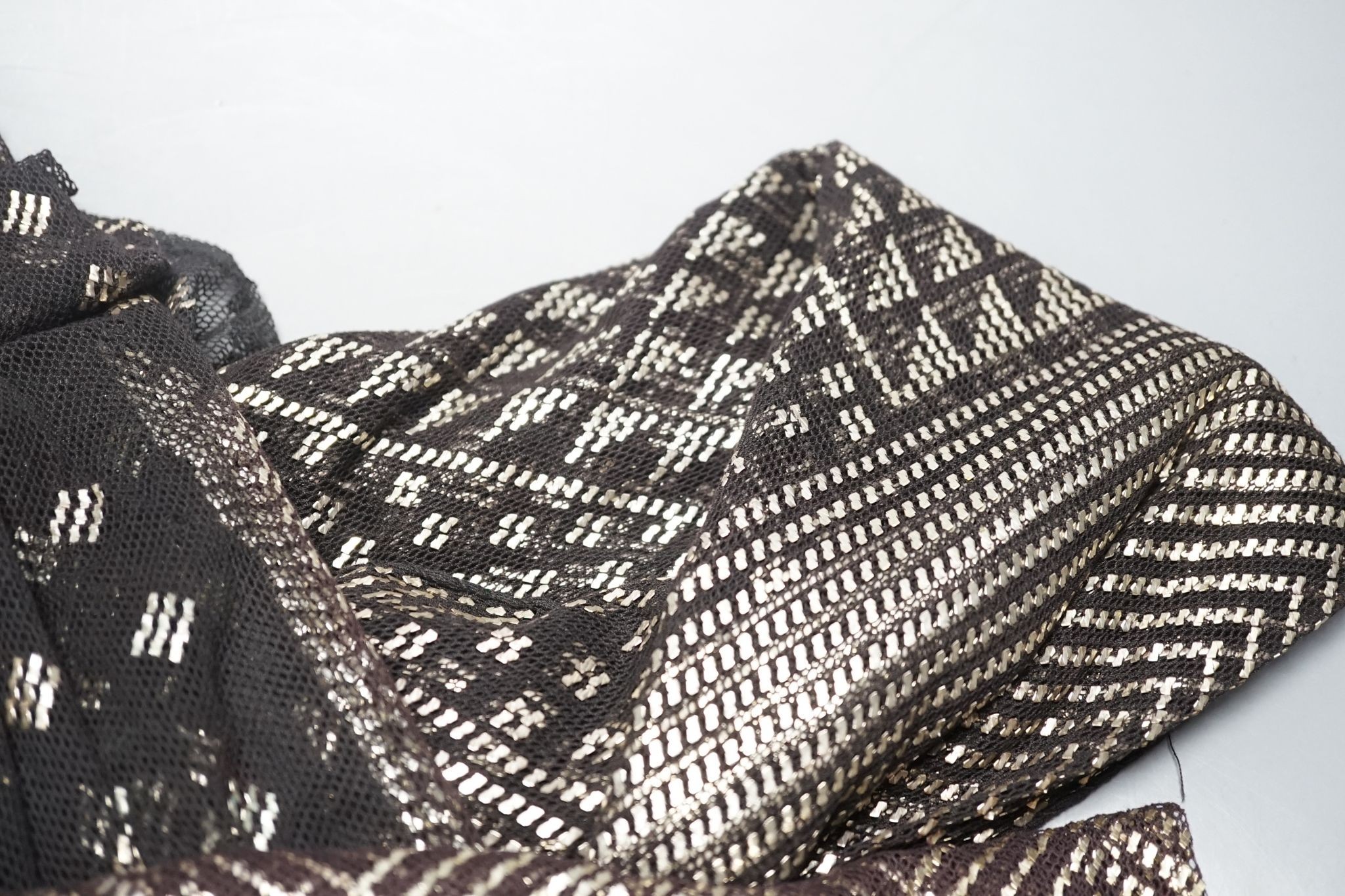 A dress made from a metal and black net Egyptian shawl; a similar shawl and a piece of shawl